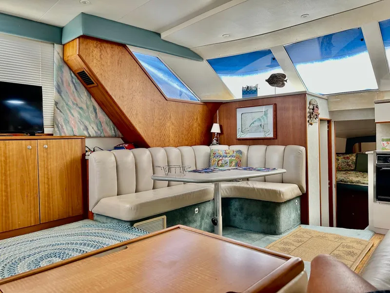 Slide: The Image of Interior of a 1997 Silverton 372 Motor Yacht with cozy seating and skylights. - 25