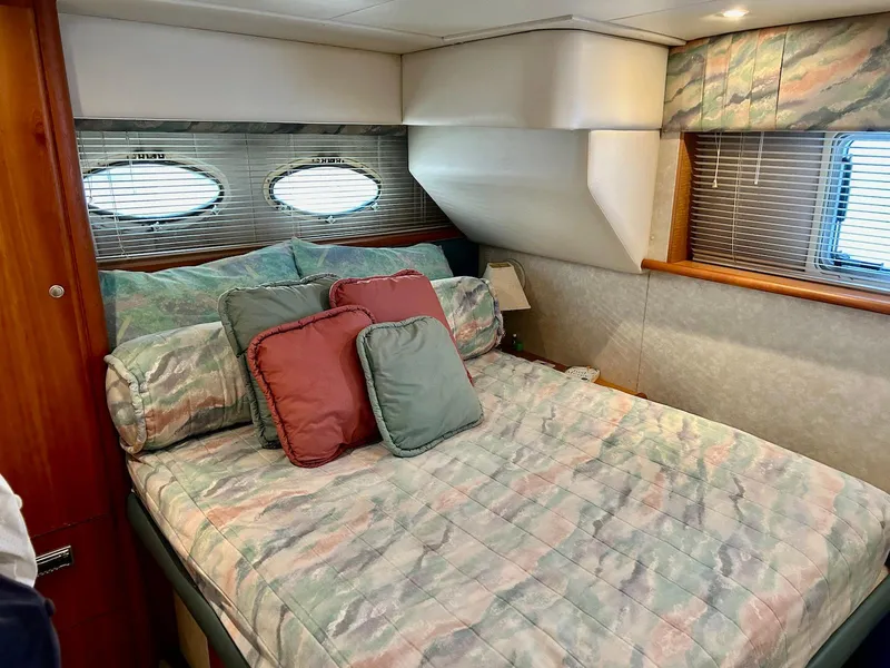 Slide: The Image of 1997 Silverton 372 Motor Yacht bedroom with cozy bed and decorative pillows. - 28