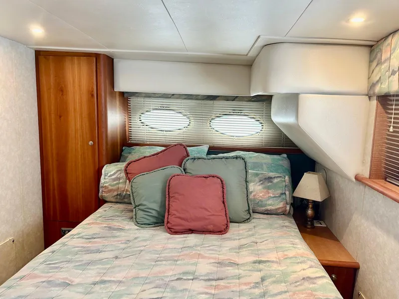 Slide: The Image of Cozy bedroom in 1997 Silverton 372 Motor Yacht with colorful bedding and wooden accents. - 29