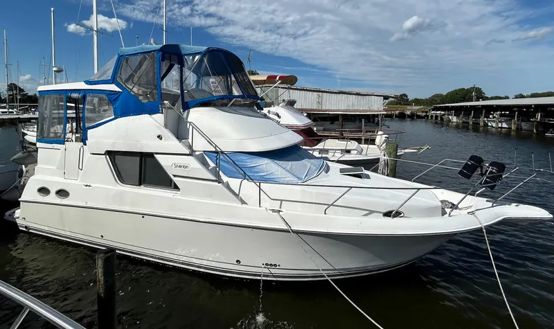 Slide: The Image of 1997 Silverton 372 Motor Yacht docked at marina under blue sky. - 3