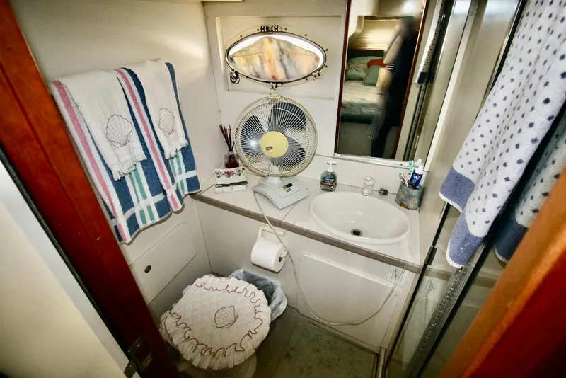 Slide: The Image of Bathroom of 1997 Silverton 372 Motor Yacht with sink, toilet, and fan. - 30