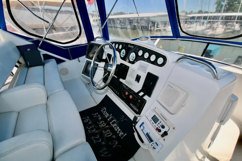 Slide: The Image of 1997 Silverton 372 Motor Yacht helm with steering wheel and navigation instruments. - 9