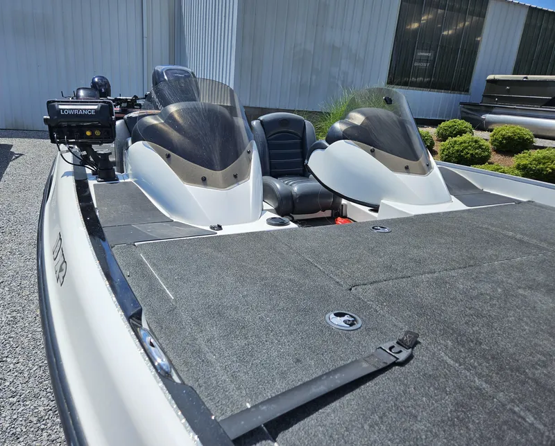 Slide: The Image of 2008 Triton 18X2 boat with dual consoles and Lowrance electronics, parked outdoors. - 5