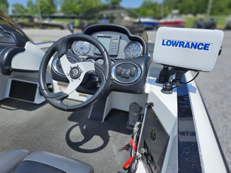 Slide: The Image of 2008 Triton 18X2 boat cockpit with steering wheel and Lowrance HDS system. - 7