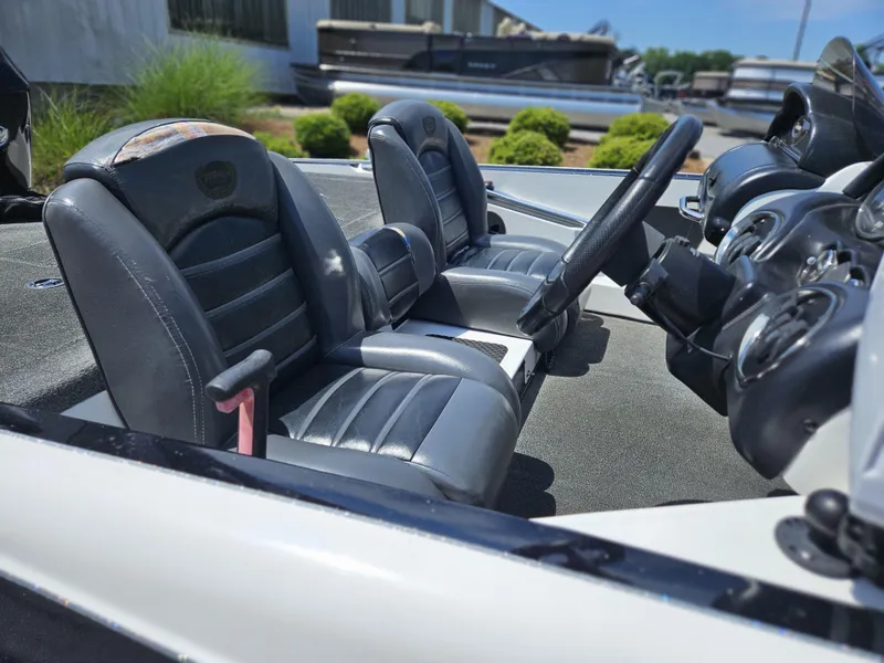 Slide: The Image of Interior of a 2008 Triton 18X2 boat with dual seats and steering wheel. - 8
