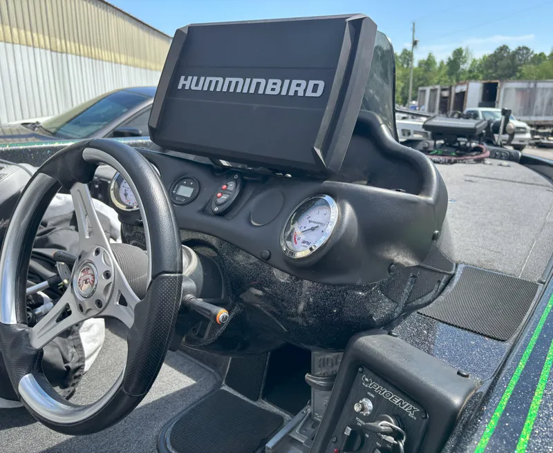 Slide: The Image of 2019 Phoenix 920 PRO XP boat dashboard with Humminbird display and steering wheel. - 17