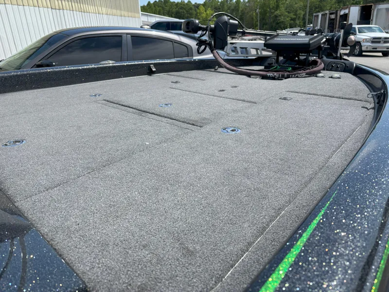 Slide: The Image of 2019 Phoenix 920 PRO XP boat deck with trolling motor, parked outdoors. - 5