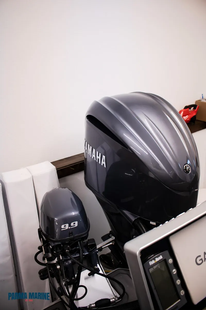 Slide: The Image of 2023 Extreme Boats 745 Game King with Yamaha outboard motors in a showroom. - 15