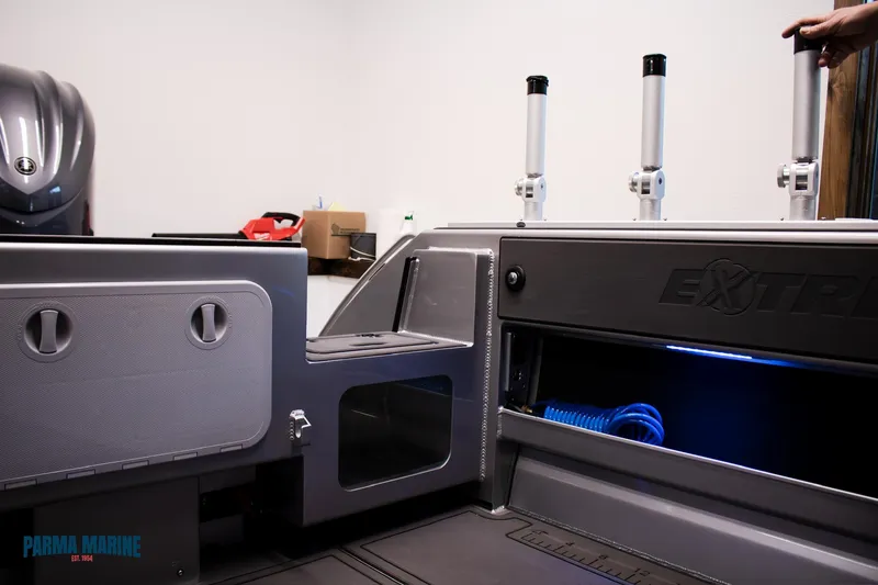 Slide: The Image of 2023 Extreme Boats 745 Game King interior with storage compartments and fishing rod holders. - 18