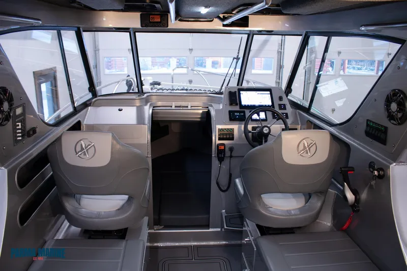 Slide: The Image of 2023 Extreme Boats 745 Game King interior with modern controls and dual seating. - 23