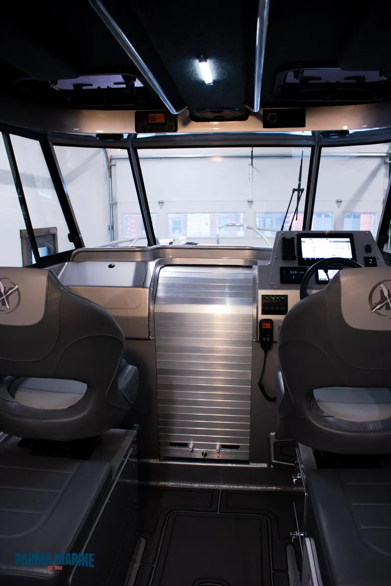 Slide: The Image of 2023 Extreme Boats 745 Game King interior with modern dashboard and seating. - 24