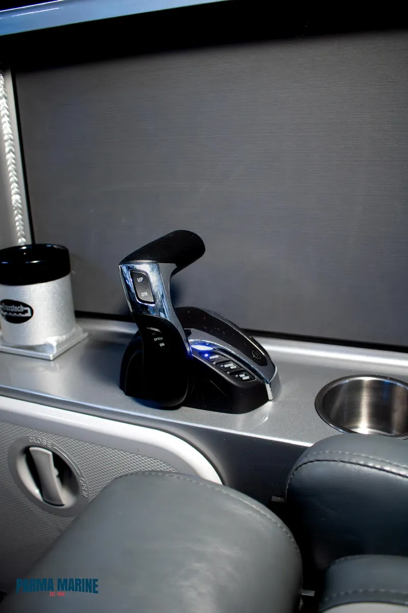 Slide: The Image of 2023 Extreme Boats 745 Game King interior with throttle control and cup holders. - 27