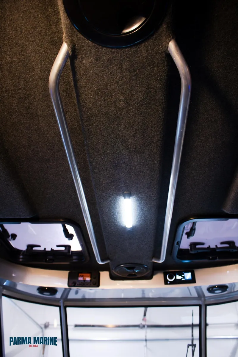 Slide: The Image of 2023 Extreme Boats 745 Game King interior ceiling with lighting and control panel. - 28