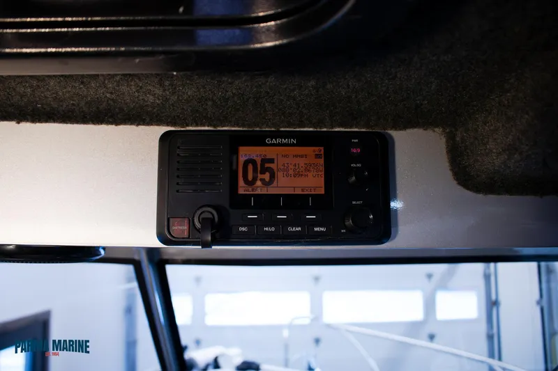 Slide: The Image of Garmin marine radio on 2023 Extreme Boats 745 Game King dashboard. - 33