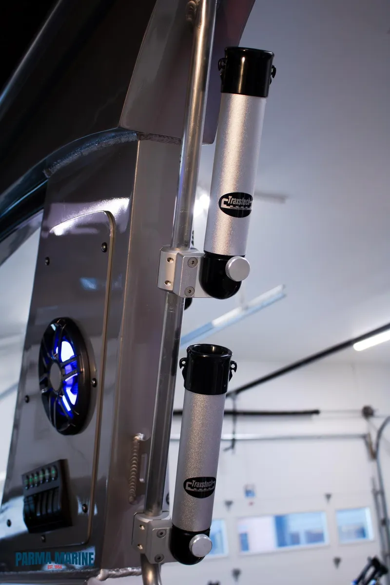 Slide: The Image of 2023 Extreme Boats 745 Game King interior with mounted rod holders and speaker. - 37