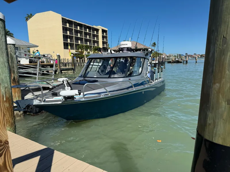 Slide: The Image of 2023 Extreme Boats 745 Game King docked in a sunny marina setting. - 6