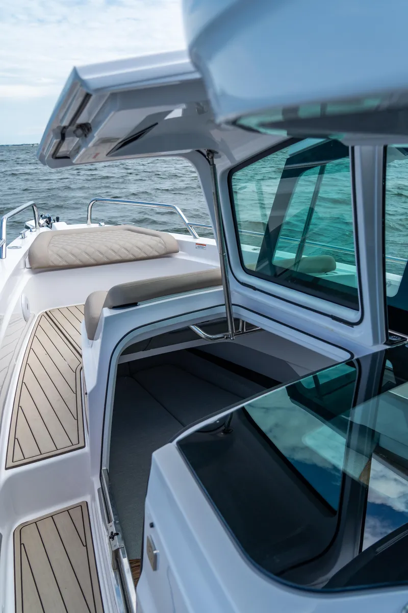 Slide: The Image of 2022 Axopar XC Aft Cabin boat with open cabin and sleek design on the water. - 11