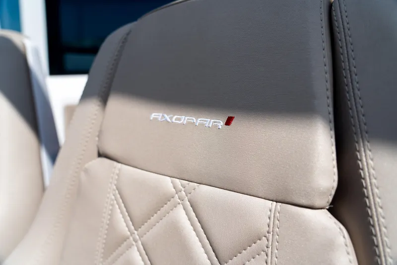 Slide: The Image of Close-up of 2022 Axopar XC Aft Cabin seat with logo and stitching. - 12