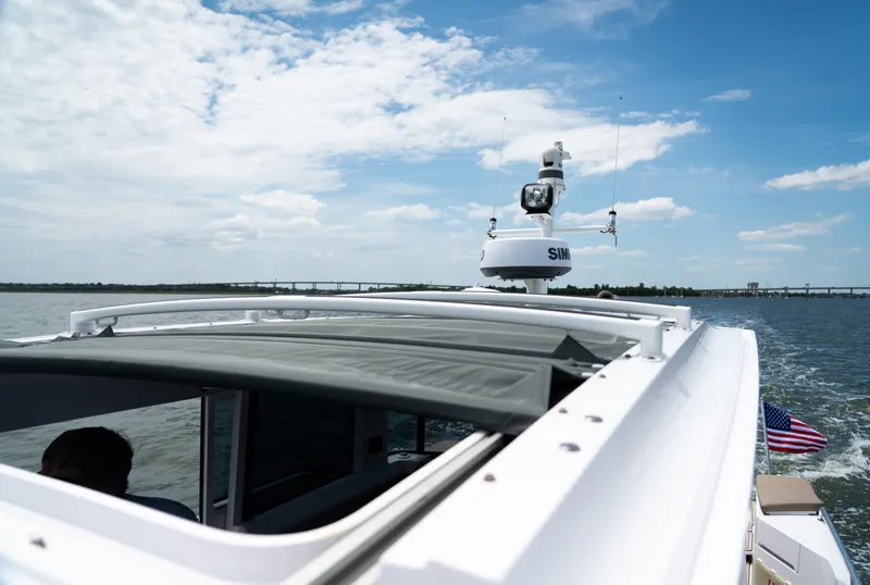 Slide: The Image of 2022 Axopar XC Aft Cabin cruising on open water under a clear blue sky. - 17