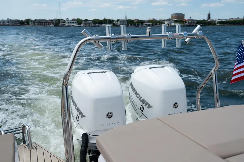 Slide: The Image of 2022 Axopar XC Aft Cabin with dual Mercury outboard engines on open water. - 22