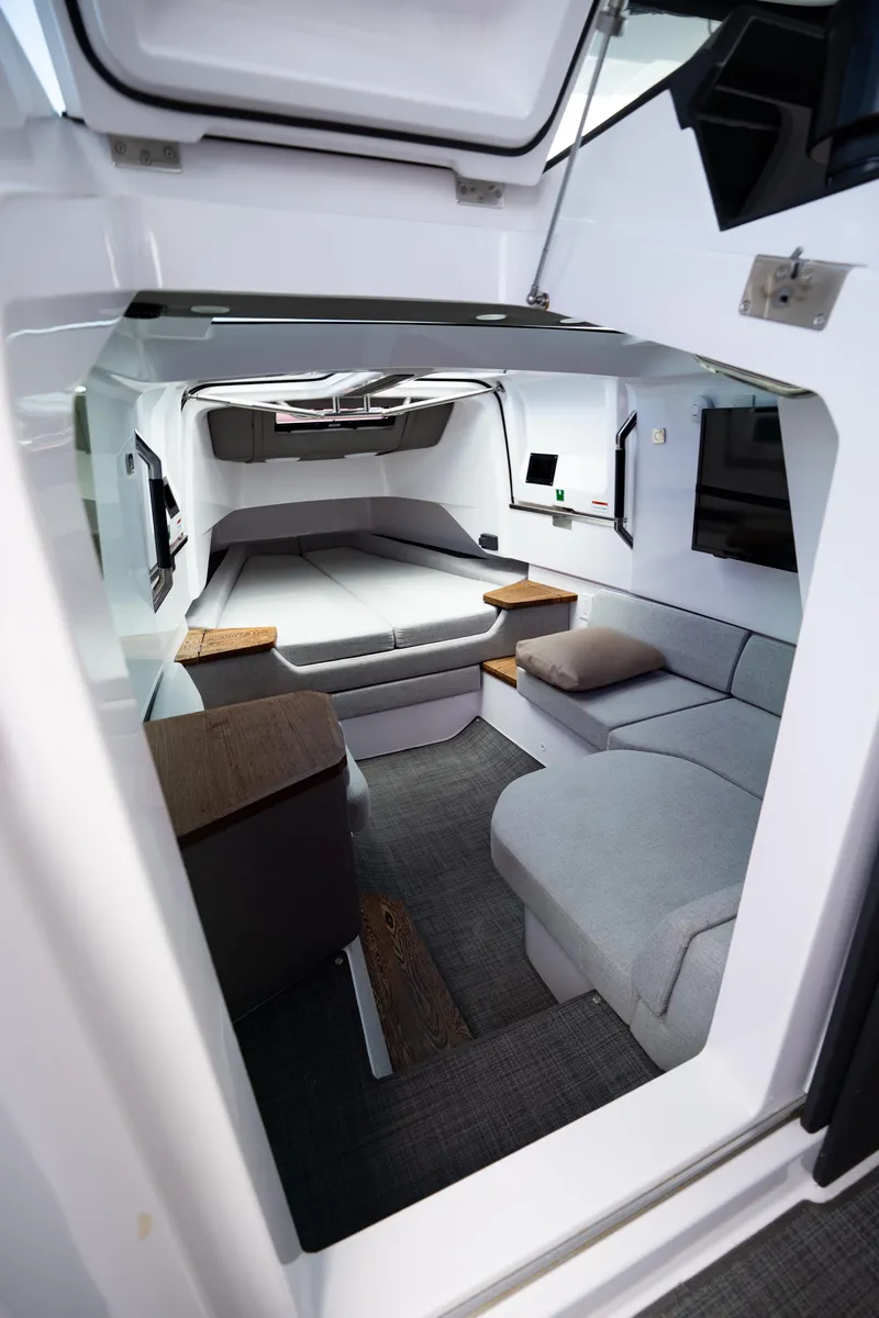 Slide: The Image of 2022 Axopar XC Aft Cabin interior with modern seating and sleek design. - 24