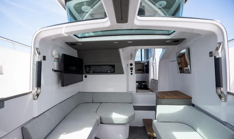 Slide: The Image of 2022 Axopar XC Aft Cabin interior with modern seating and skylight. - 26
