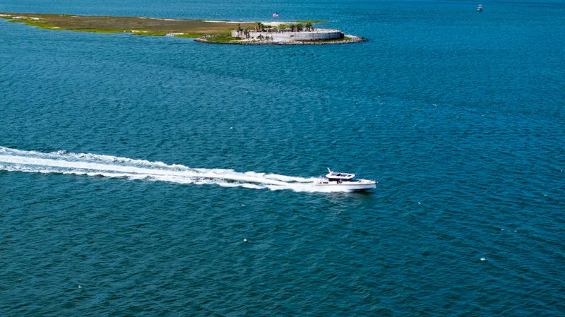 Slide: The Image of 2022 Axopar XC Aft Cabin cruising on blue ocean near small island. - 32