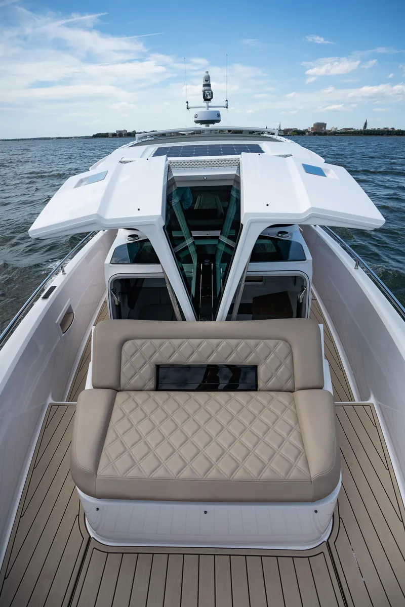 Slide: The Image of 2022 Axopar XC Aft Cabin boat with open deck and cushioned seating. - 8
