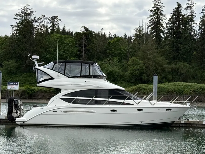 Slide: The Image of 2006 Meridian 391 Sedan yacht docked by a forested shoreline. - 0