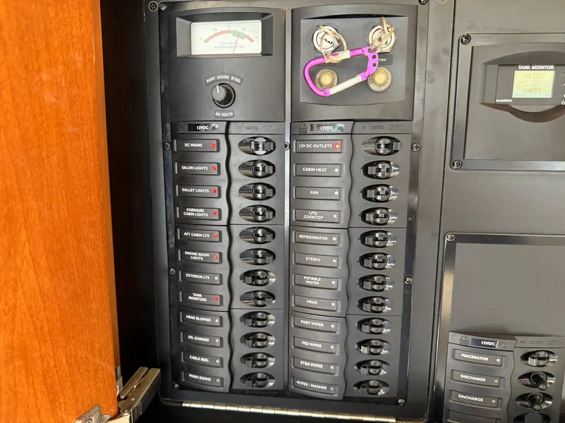 Slide: The Image of Electrical panel on a 2006 Meridian 391 Sedan boat with labeled switches and gauges. - 11