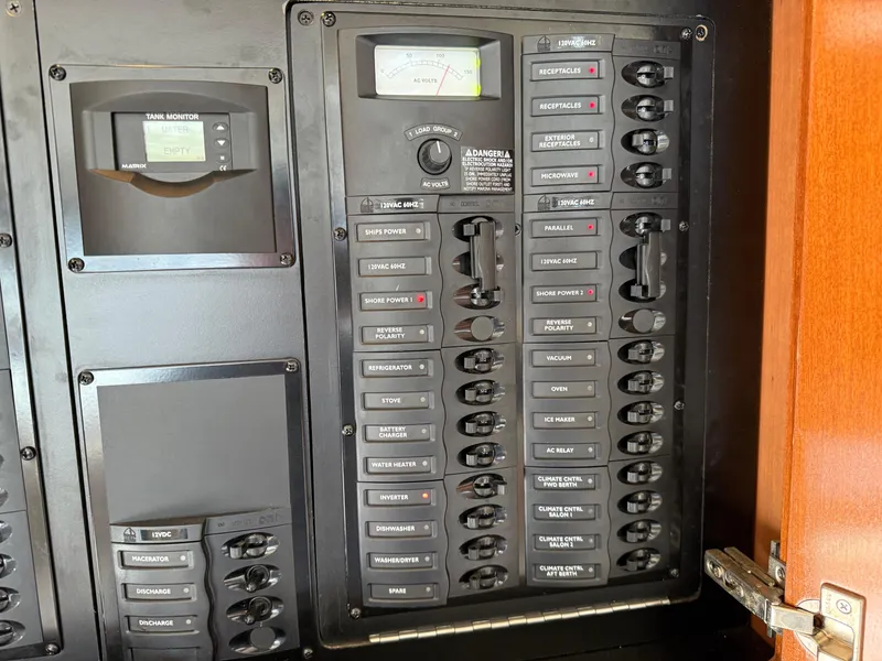 Slide: The Image of Electrical panel on a 2006 Meridian 391 Sedan boat, featuring labeled switches and gauges. - 12