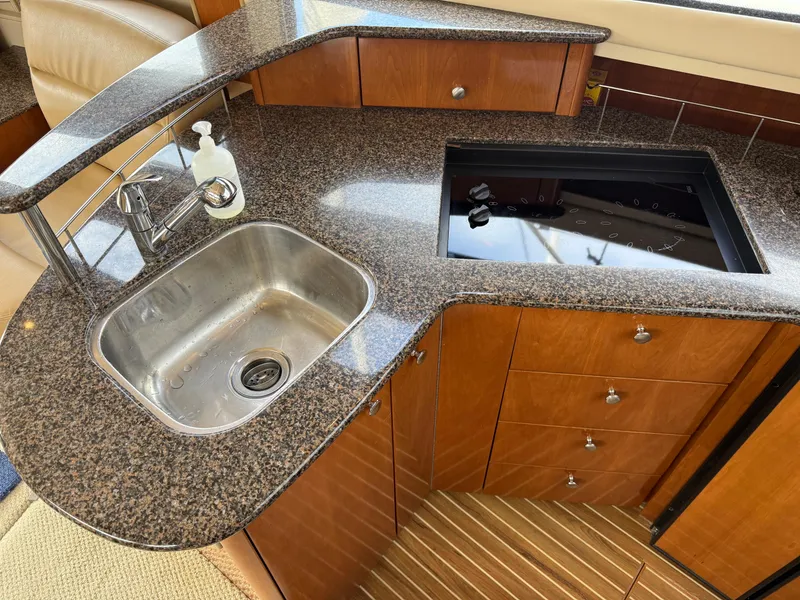 Slide: The Image of 2006 Meridian 391 Sedan yacht kitchen with granite countertop and stainless steel sink. - 16