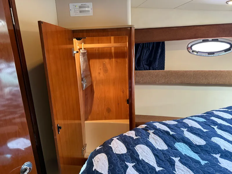 Slide: The Image of Interior of 2006 Meridian 391 Sedan with open wooden closet and fish-patterned bedspread. - 21
