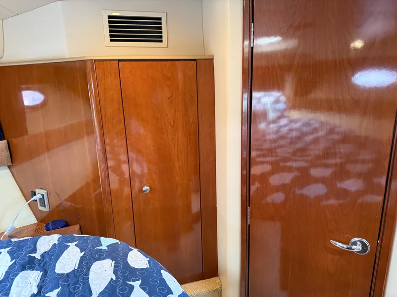 Slide: The Image of 2006 Meridian 391 Sedan interior with wooden cabinetry and fish-patterned bedding. - 22