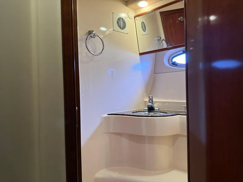Slide: The Image of 2006 Meridian 391 Sedan yacht bathroom with sink, mirror, and porthole window. - 28