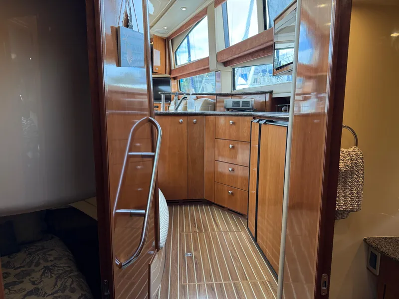 Slide: The Image of Interior view of 2006 Meridian 391 Sedan yacht kitchen with wood cabinetry and modern appliances. - 31