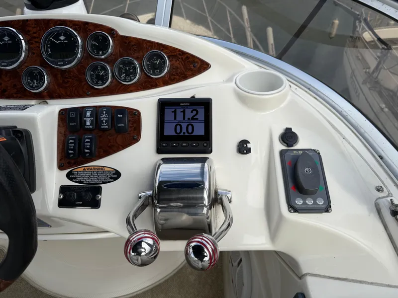 Slide: The Image of Control panel of a 2006 Meridian 391 Sedan boat with gauges and throttle. - 37
