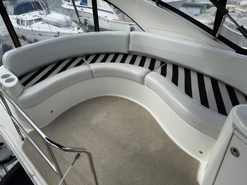 Slide: The Image of 2006 Meridian 391 Sedan yacht interior with curved seating and striped cushions. - 40