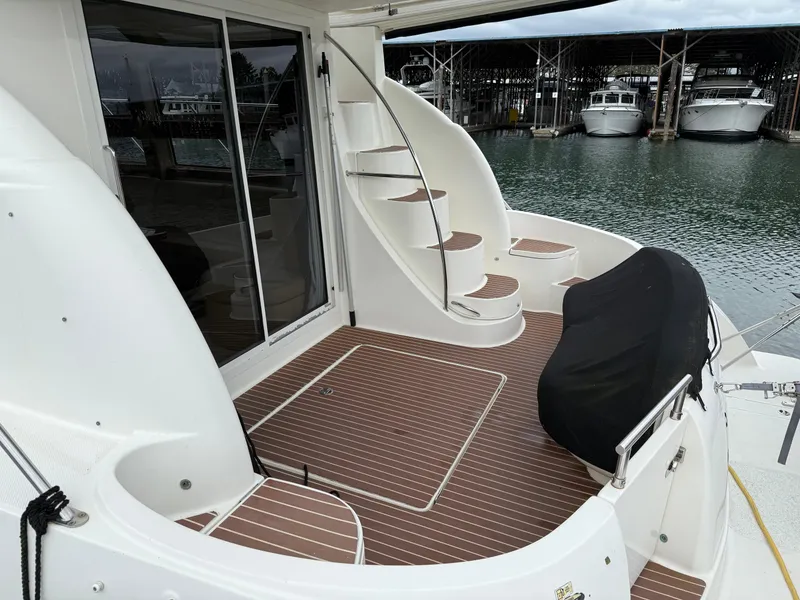 Slide: The Image of 2006 Meridian 391 Sedan yacht deck with spiral staircase and covered seating area. - 43