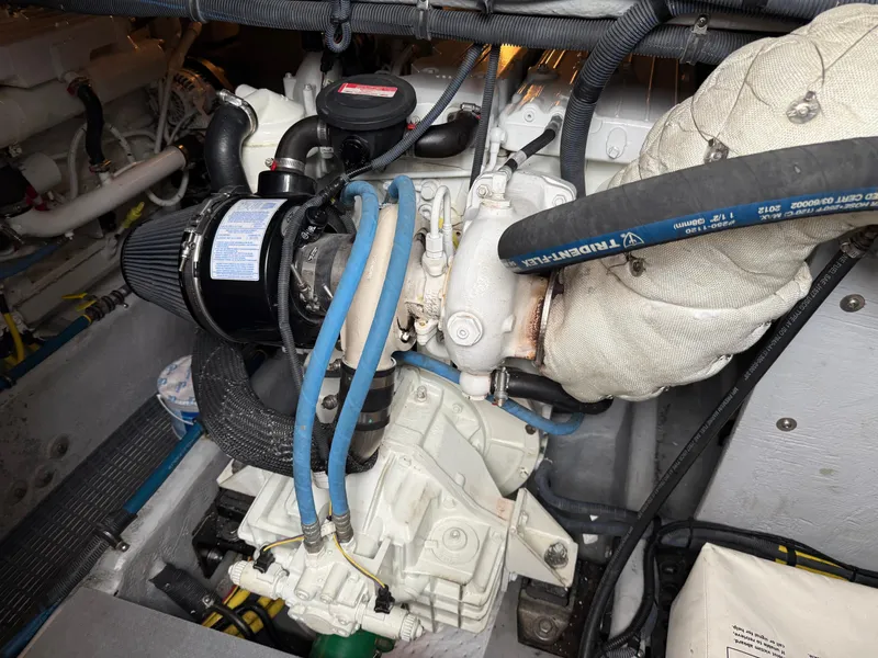 Slide: The Image of Engine compartment of a 2006 Meridian 391 Sedan boat, showcasing mechanical components and hoses. - 46