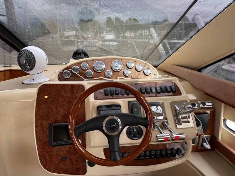 Slide: The Image of 2006 Meridian 391 Sedan helm with wood accents and modern controls. - 9