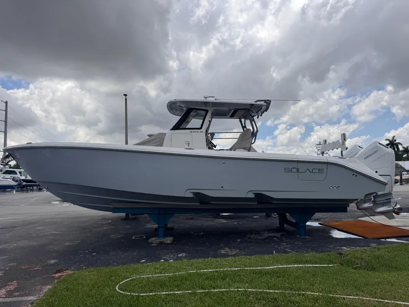 The Image of 2025 Solace 32 CS boat on display under cloudy sky. - 0