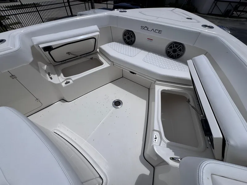 Slide: The Image of 2025 Solace 32 CS boat interior with storage compartments and seating. - 10