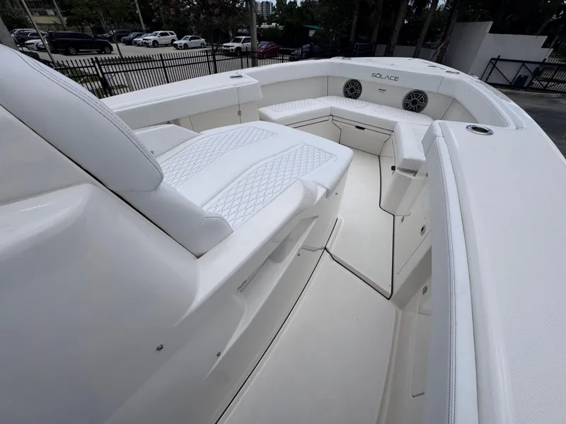Slide: The Image of 2025 Solace 32 CS boat interior with white seating and modern design. - 11