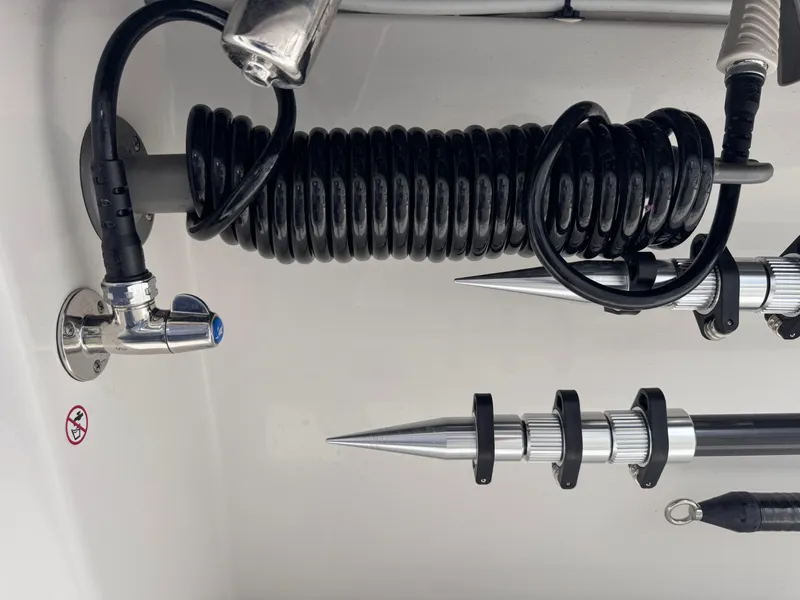 Slide: The Image of Coiled hose and metal fixtures on 2025 Solace 32 CS boat. - 18