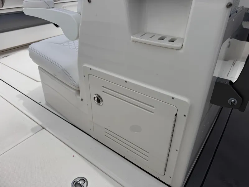 Slide: The Image of 2025 Solace 32 CS boat interior with storage compartment and cushioned seating. - 20