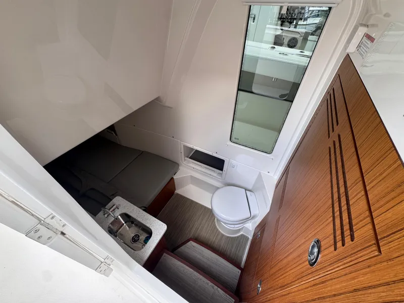 Slide: The Image of Interior cabin of 2025 Solace 32 CS boat with toilet and seating area. - 22