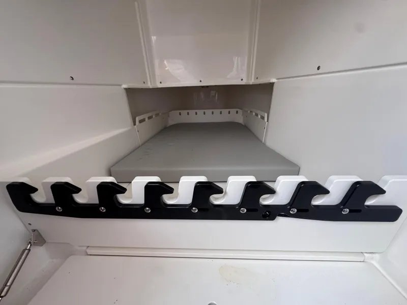 Slide: The Image of Interior storage compartment of 2025 Solace 32 CS boat with rod holders. - 24