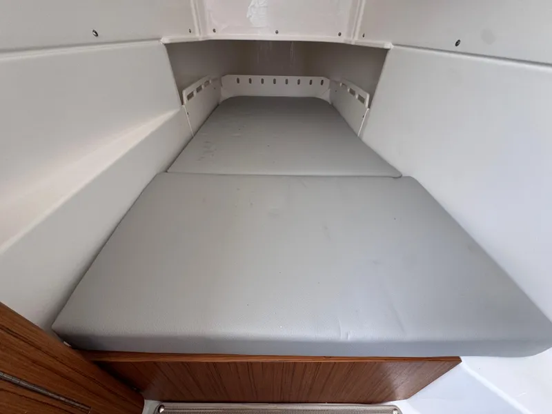 Slide: The Image of 2025 Solace 32 CS boat cabin interior with cushioned bed. - 25