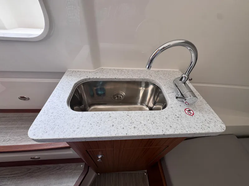 Slide: The Image of 2025 Solace 32 CS boat sink with modern faucet and granite countertop. - 27